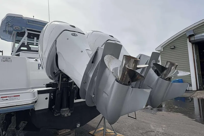 Slide: The Image of 2023 Blackfin 332cc boat with dual outboard engines at a dockside location. - 19