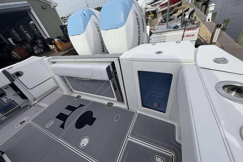 Slide: The Image of 2023 Blackfin 332cc boat deck with Mercury engines and storage compartments. - 22