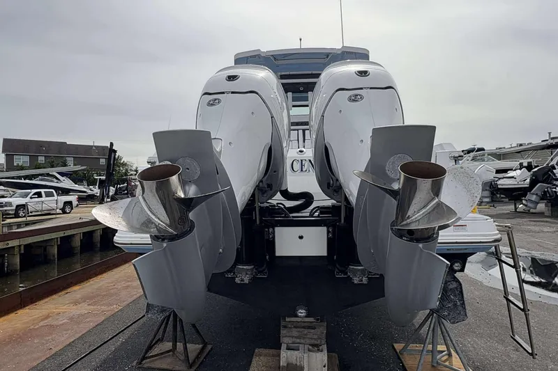 Slide: The Image of 2023 Blackfin 332cc boat with dual outboard engines on display at a marina. - 28