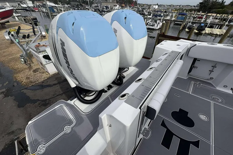 Slide: The Image of 2023 Blackfin 332cc boat with twin Mercury outboard engines at a marina dock. - 29