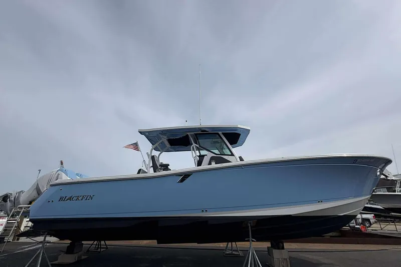 Slide: The Image of 2023 Blackfin 332cc boat displayed on stands, side view. - 3