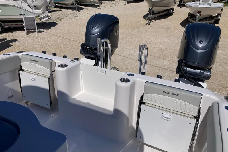 Slide: The Image of 2026 Twin Vee 280 GFX CC boat with dual Yamaha outboard engines, docked on gravel. - 13