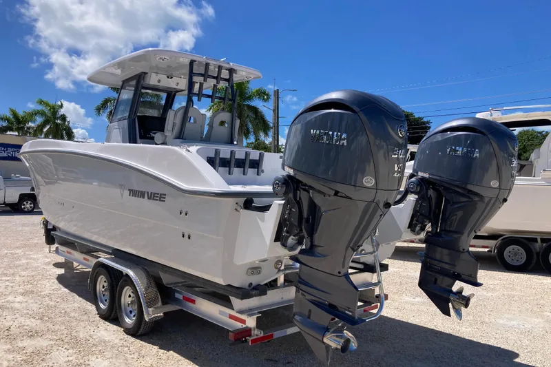 Slide: The Image of 2026 Twin Vee 280 GFX CC boat with dual Yamaha outboard engines on a trailer. - 3