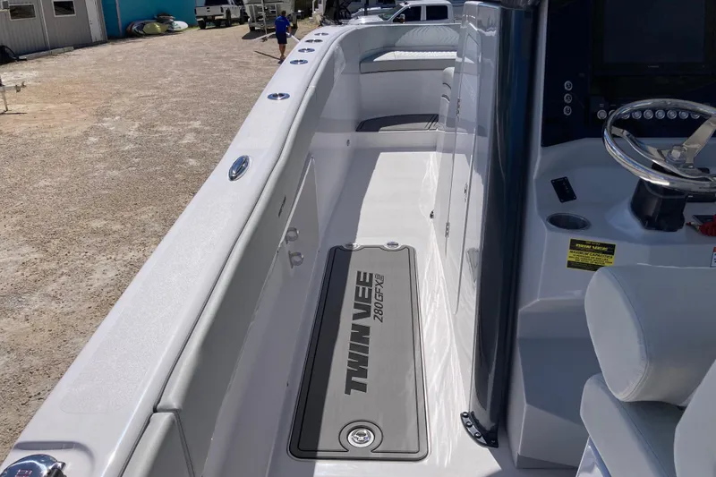 Slide: The Image of 2026 Twin Vee 280 GFX CC boat interior with steering wheel and seating area. - 6