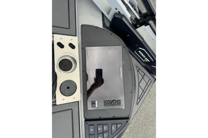 Slide: The Image of Control panel of 2026 Caymas XS 20 Pro boat with touchscreen and cup holder. - 12