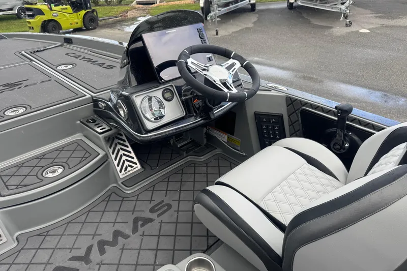 Slide: The Image of 2026 Caymas XS 20 Pro boat interior with steering wheel and dashboard controls. - 17
