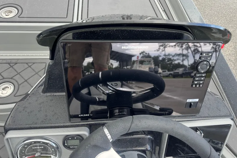 Slide: The Image of 2026 Caymas XS 20 Pro boat dashboard with Humminbird Xplore 12 display and steering wheel. - 18