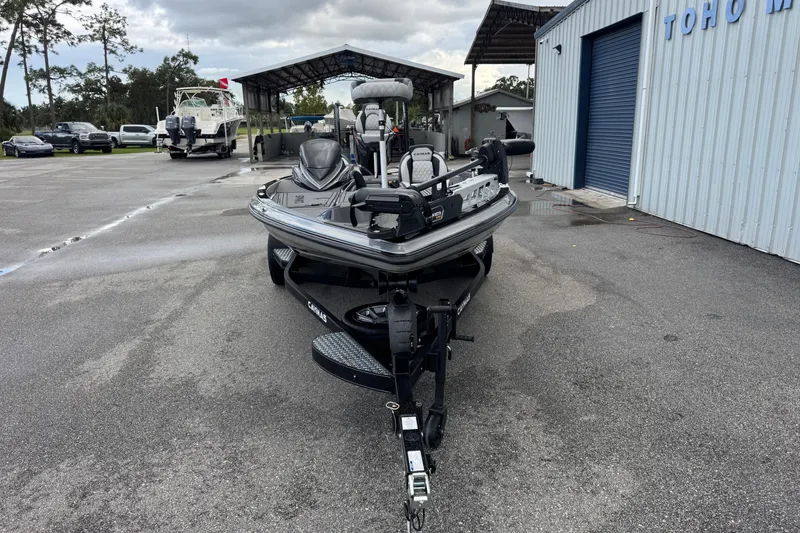 Slide: The Image of 2026 Caymas XS 20 Pro boat on trailer, parked outside a marine facility. - 4