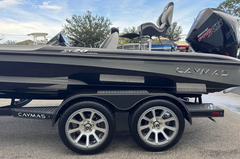 Slide: The Image of 2026 Caymas XS 20 Pro boat on trailer, featuring sleek design and Mercury Pro XS engine. - 7