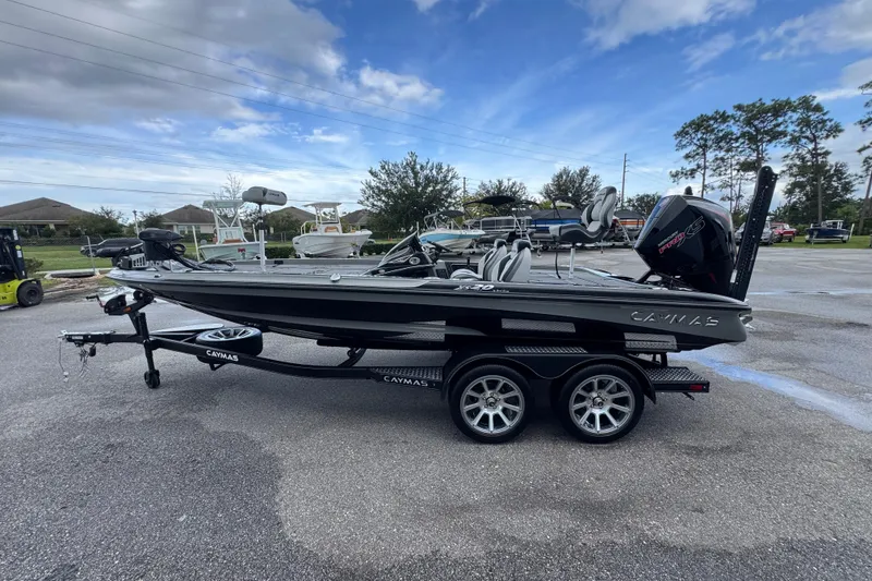 Slide: The Image of 2026 Caymas XS 20 Pro boat on trailer, parked outdoors under a cloudy sky. - 8