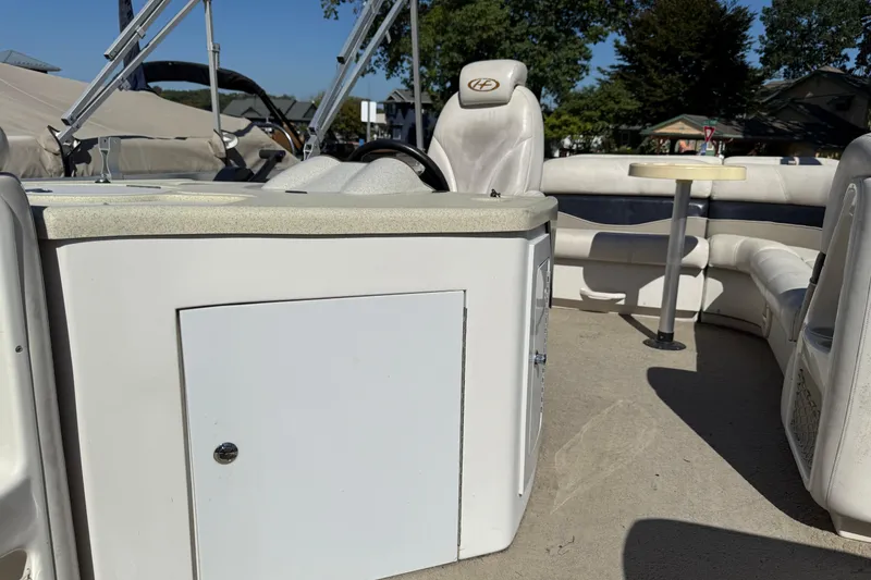 Slide: The Image of 2005 Harris FloteBote 270 Crowne pontoon boat interior with seating and helm. - 11