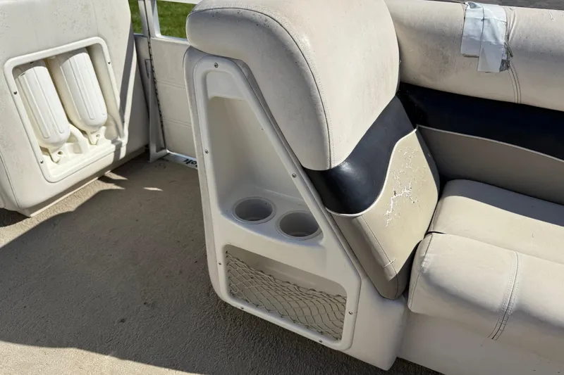 Slide: The Image of 2005 Harris FloteBote 270 Crowne boat interior with cup holders and seating. - 13
