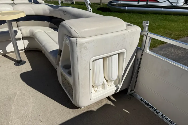 Slide: The Image of Interior of 2005 Harris FloteBote 270 Crowne with cushioned seating and cup holders. - 14