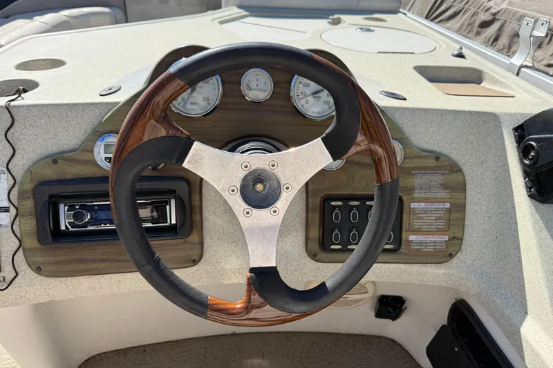 Slide: The Image of Steering wheel and dashboard of 2005 Harris FloteBote 270 Crowne boat. - 17