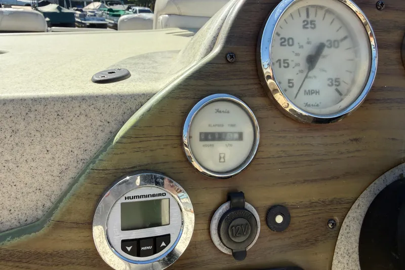 Slide: The Image of Dashboard of a 2005 Harris FloteBote 270 Crowne with speedometer and Humminbird display. - 18