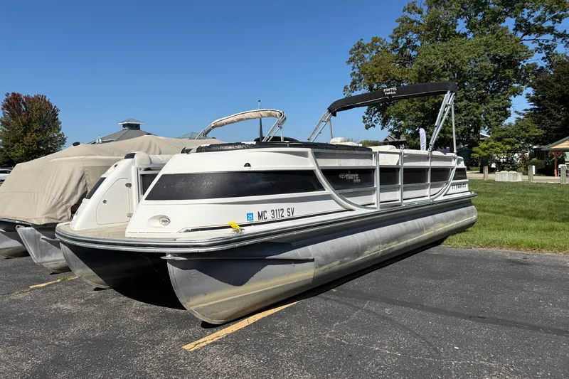 Slide: The Image of 2005 Harris FloteBote 270 Crowne pontoon boat parked on pavement. - 2