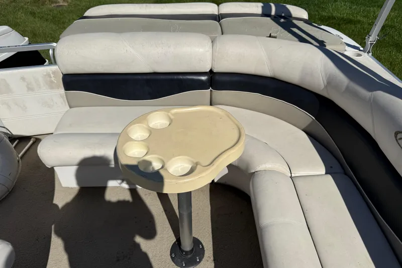 Slide: The Image of 2005 Harris FloteBote 270 Crowne interior with beige seating and cup holder table. - 20