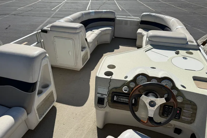 Slide: The Image of 2005 Harris FloteBote 270 Crowne pontoon boat interior with steering console and seating. - 21