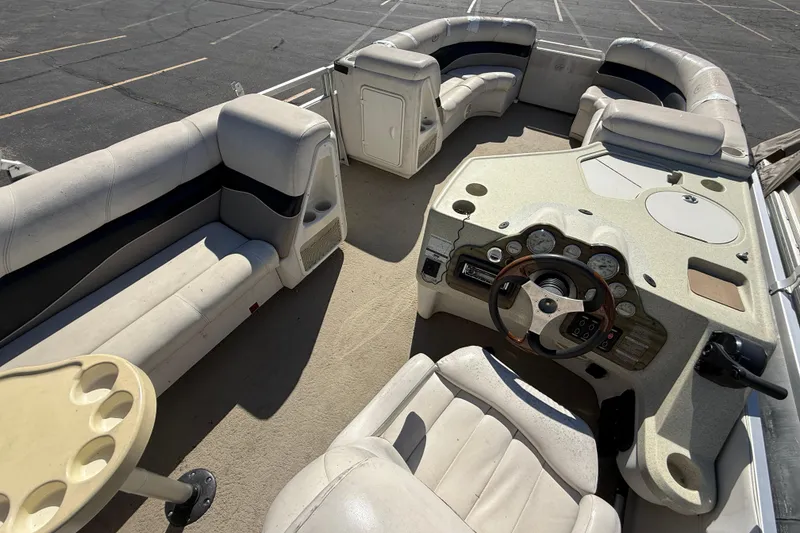Slide: The Image of 2005 Harris FloteBote 270 Crowne pontoon boat interior with seating and steering console. - 22