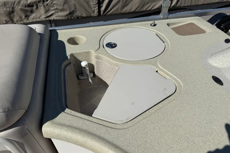 Slide: The Image of 2005 Harris FloteBote 270 Crowne boat sink and counter area with storage compartments. - 24