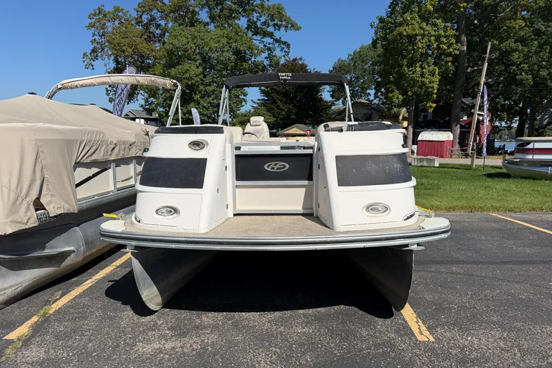 Slide: The Image of 2005 Harris FloteBote 270 Crowne pontoon boat parked on asphalt near trees. - 3