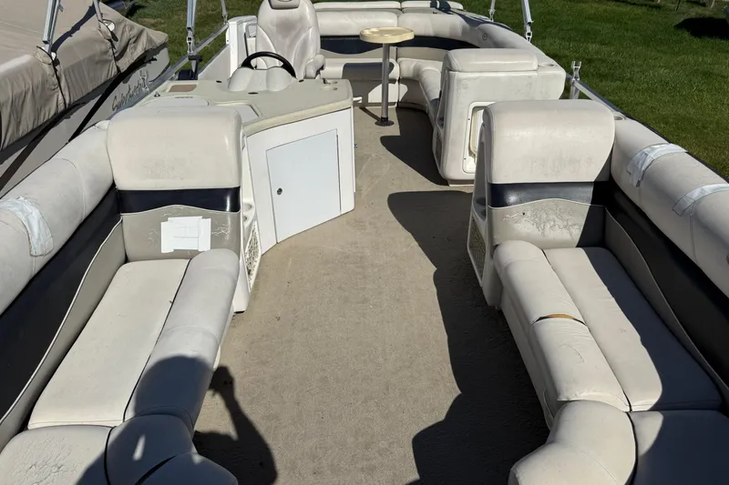 Slide: The Image of 2005 Harris FloteBote 270 Crowne pontoon boat interior with seating and table. - 7
