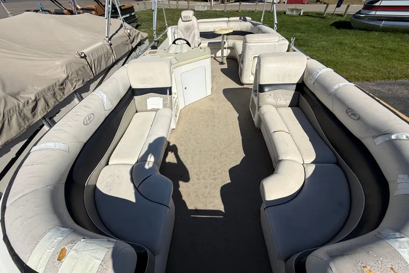 Slide: The Image of 2005 Harris FloteBote 270 Crowne pontoon boat interior with spacious seating and table. - 8