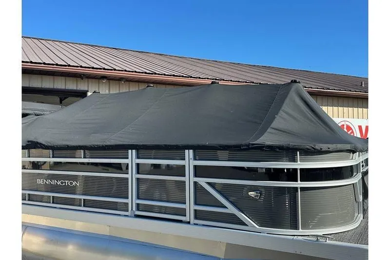 The Image of 2025 Bennington 20 SF Family pontoon boat with cover, parked outdoors. - 1