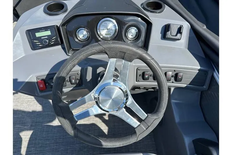 Slide: The Image of 2025 Bennington 20 SF Family boat dashboard with steering wheel and gauges. - 12