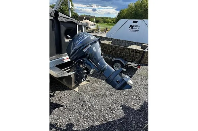 Slide: The Image of 2025 Bennington 20 SF Family boat with Yamaha outboard motor in a scenic outdoor setting. - 4