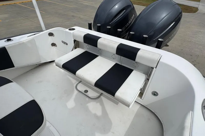 Slide: The Image of 2018 Cape Horn 27 boat interior with black and white seating and Yamaha engines. - 18