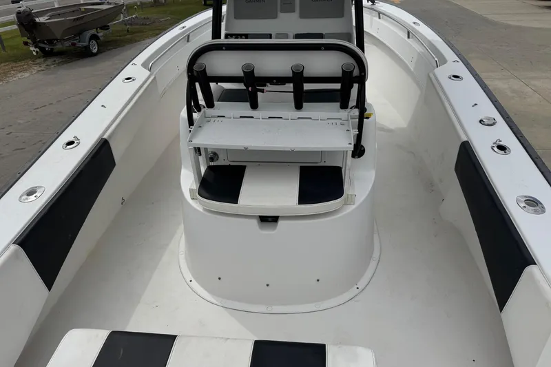 Slide: The Image of 2018 Cape Horn 27 boat interior with seating and console, docked outdoors. - 23