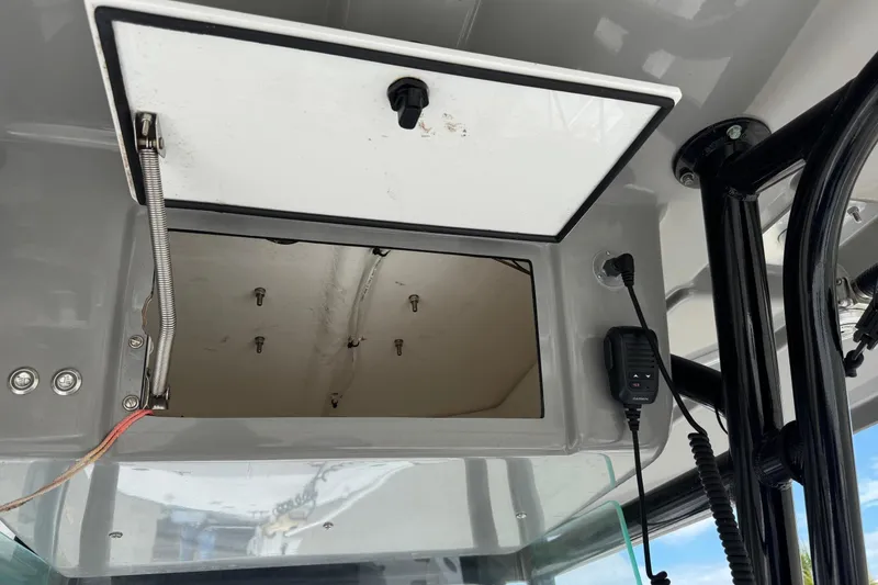 Slide: The Image of Open storage compartment on 2018 Cape Horn 27 boat with communication device. - 9