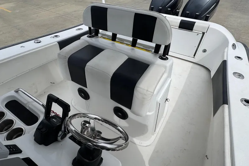 Slide: The Image of 2018 Cape Horn 27 boat interior with black and white seating and dual engines. - 15