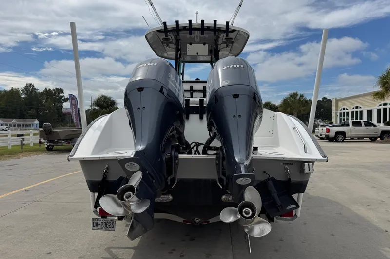 Slide: The Image of 2018 Cape Horn 27 boat with dual outboard engines, parked outdoors. - 4