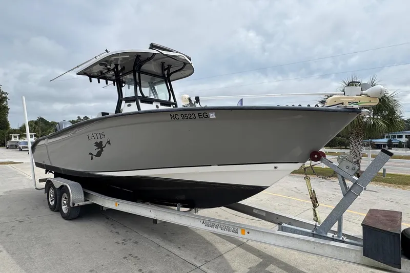 Slide: The Image of 2018 Cape Horn 27 boat on trailer, parked outdoors under cloudy sky. - 6