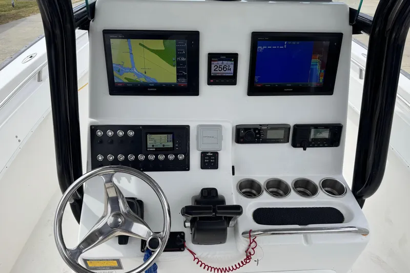 Slide: The Image of 2018 Cape Horn 27 boat dashboard with navigation screens and controls. - 8