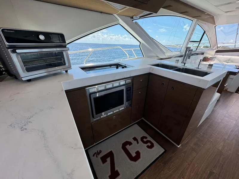 Slide: The Image of Modern kitchen in 2021 Cruisers Yachts 60 Cantius Flybridge with ocean view. - 17