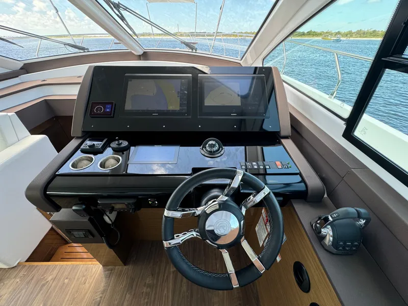 Slide: The Image of Helm of 2021 Cruisers Yachts 60 Cantius Flybridge with modern navigation displays. - 24