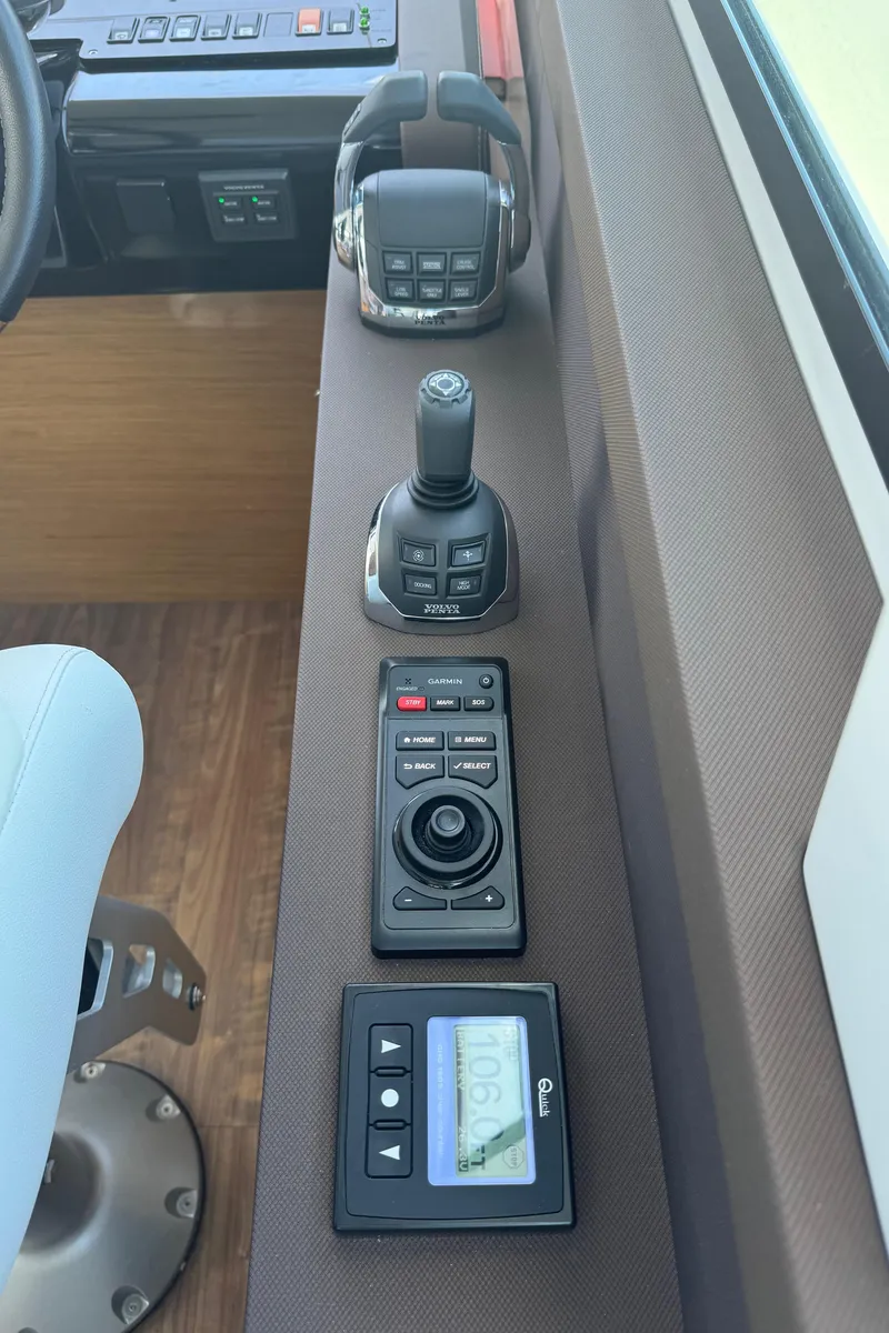 Slide: The Image of Control panel of 2021 Cruisers Yachts 60 Cantius Flybridge with joystick and digital display. - 25