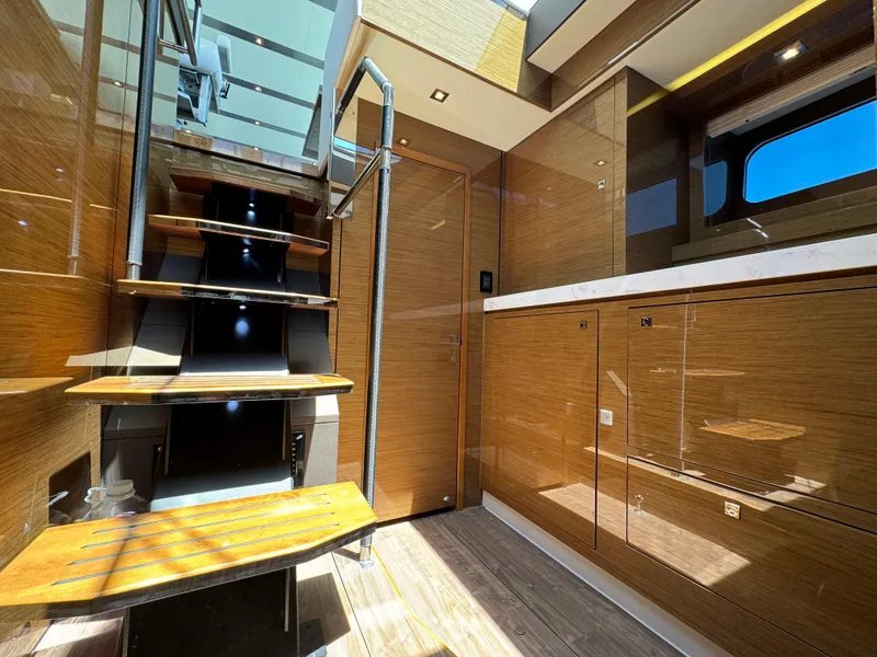 Slide: The Image of Luxurious interior of 2021 Cruisers Yachts 60 Cantius Flybridge with wooden stairs and modern design. - 27