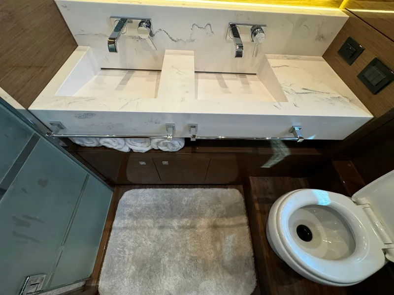 Slide: The Image of Luxurious bathroom in 2021 Cruisers Yachts 60 Cantius Flybridge, featuring dual sinks and modern fixtures. - 33