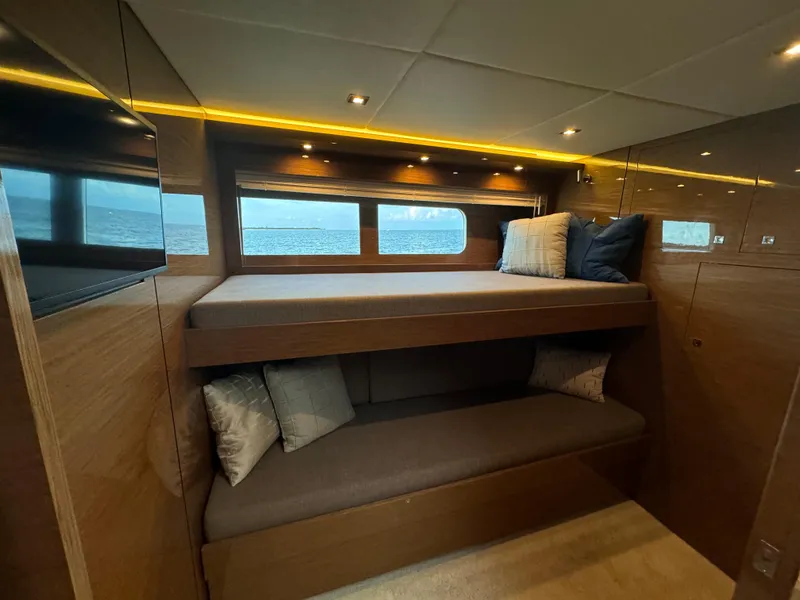 Slide: The Image of Luxurious 2021 Cruisers Yachts 60 Cantius Flybridge cabin with cozy bunk beds and ocean view. - 36