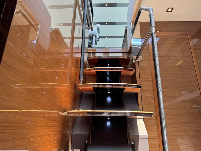 Slide: The Image of Staircase on 2021 Cruisers Yachts 60 Cantius Flybridge with sleek wood and metal design. - 37
