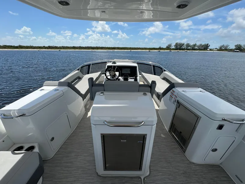 Slide: The Image of 2021 Cruisers Yachts 60 Cantius Flybridge interior with helm, seating, and water view. - 47