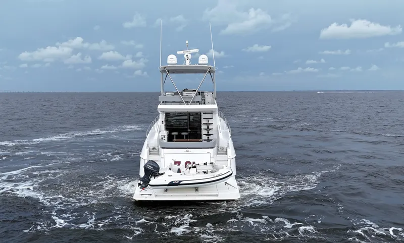 Slide: The Image of 2021 Cruisers Yachts 60 Cantius Flybridge on open sea, rear view. - 5