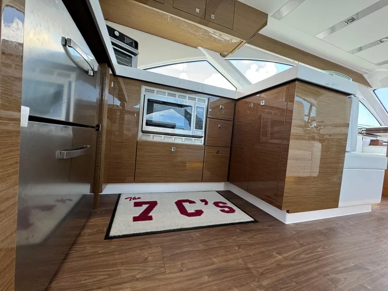 Slide: The Image of Modern kitchen interior of 2021 Cruisers Yachts 60 Cantius Flybridge with wood finish. - 16