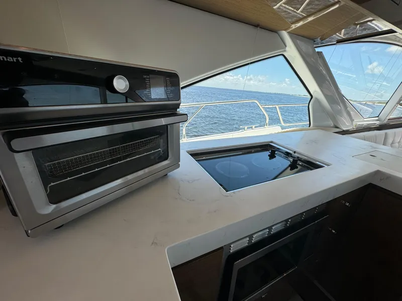 Slide: The Image of Modern kitchen on 2021 Cruisers Yachts 60 Cantius Flybridge with ocean view. - 18