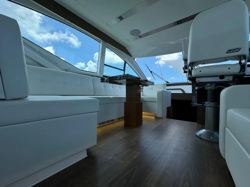 Slide: The Image of Luxurious interior of 2021 Cruisers Yachts 60 Cantius Flybridge with sleek seating and panoramic windows. - 21