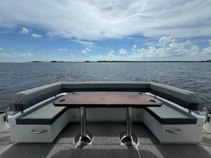 Slide: The Image of 2021 Cruisers Yachts 60 Cantius Flybridge, rear seating area with ocean view. - 41